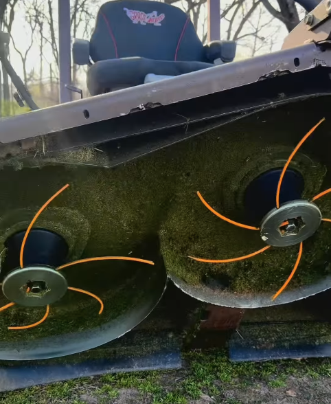 REVOsafe REVO6 2.0 mower blade replacement system installed under a mower deck with REVOline cutting elements